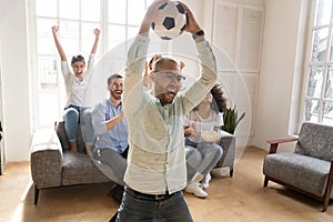 Excited African American man celebrating favorite football team goal