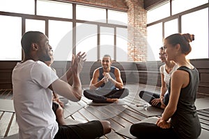 Excited african-american man talking to diverse friends sitting