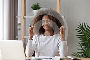 Excited African American pupil satisfied with grade photo