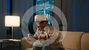 Excited African American woman play video game in VR helmet use controllers swimming simulation virtual reality