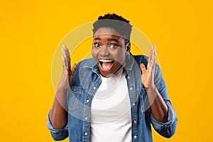 Excited African Woman Shouting In Excitement Posing Over Yellow Background