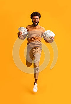 Excited afro guy celebrating successful financial operation