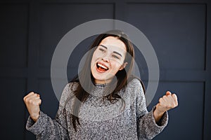 Excited agitated euphoric woman make win gesture