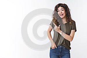 Excited amused attractive armenian cute woman with curly hairstyle laughing joyfully look impressed fascinated pointing