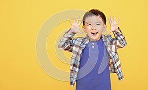 Excited asian boy  gesturing actively with both hands