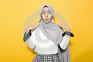 Excited asian woman with open mouth wearing hijab photo