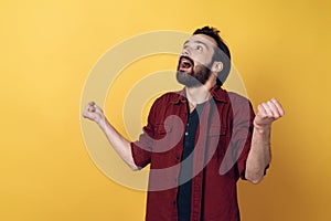 Excited Attractive Bearded Man Clenching Fists