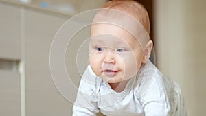 Excited baby girl crawls on floor and finds interesting toy