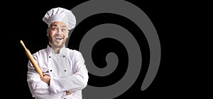 Excited Baker Posing With Dough Rolling Pin Over Black Background