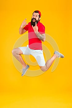 Excited bearded man jumping. full of energy. Impetuous movement. dedicated to sport and fitness. active runner in move