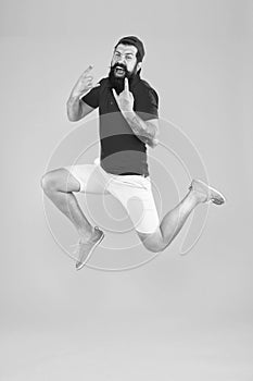 Excited bearded man jumping. full of energy. Impetuous movement. dedicated to sport and fitness. active runner in move