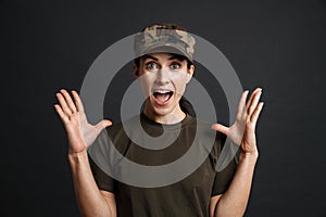 Excited beautiful soldier woman expressing surprise on camera