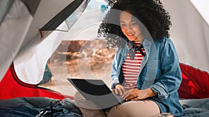 Excited Beautiful Young Multiethnic Female Traveller with Afro Hairstyle Using Laptop Computer in a
