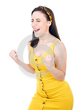Excited beautiful young woman with closed eyes and clenched fists, isolated on white background. Yes concept. Good news