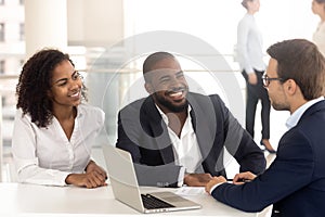 Excited black couple speak with realtor buying property together photo