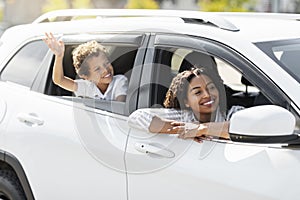 Excited black family mother and son enjoying car ride