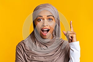 Excited Black Girl In Hijab Having Idea, Pointing Finger Up