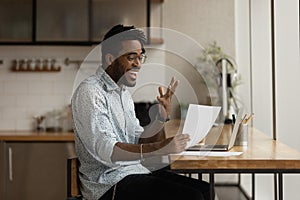 Excited black man read official letter about admission to college