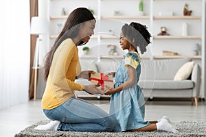 Excited Black Woman Receiving Present For Mother& x27;s Day From Her Little Daughter