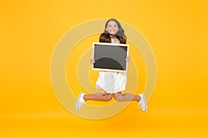 So excited. Blank blackboard. Something you need to know. Happy smiling girl hold blackboard. Small kid with blackboard