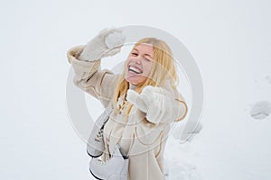 Excited blond hair girl i winter clothes outdoor. Beautiful winter woman laughing outdoors. Beauty Joyful Girl having