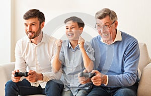 Excited Boy, Father And Grandpa Playing Video Games At Home