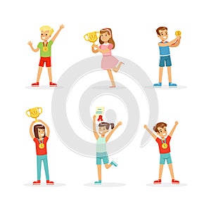 Excited Boy and Girl Winner Standing with Gold Cup and Medals as Achievement Award Vector Set