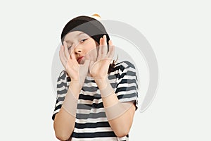 Excited boy having fun and posing at studio. Portrait of eleven years old boy. Boy wearing stylish woolen hat and tshirt