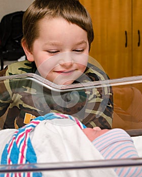 Excited boy meets his infant sibling after delivery
