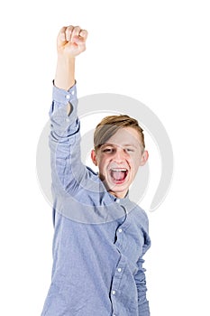 Excited boy teenager raising one hand up, holding fist and screaming as achieving success. Positive emotions celebrating victory