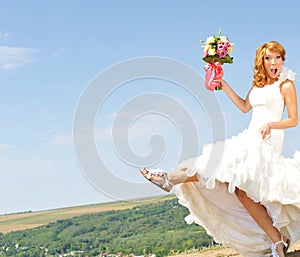 Excited bride on country hill