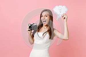 Excited bride woman in wedding dress hold retro vintage photo camera, Say cloud speech bubble with lightbulb choosing