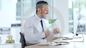 Excited business man cheering at his desk. Successful male banker or happy financial advisor celebrating his trading