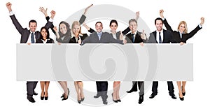 Excited business people presenting empty banner