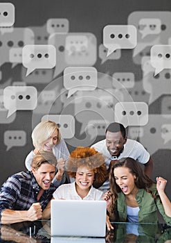 Excited business people with speech bubbles looking at a computer against grey background