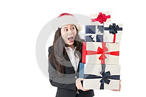 Excited business woman holding many Christmas gifts