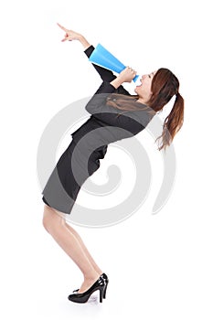 Excited business woman yelling through megaphone