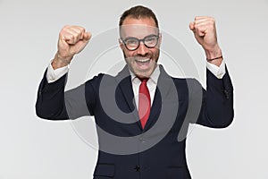 Excited businessman is celebrating success with arms in the air