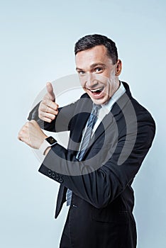 Excited businessman loving his new digital wrist watch