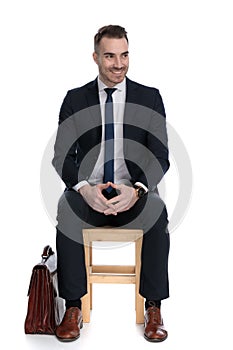 Excited businessman playing with his hands and looking away