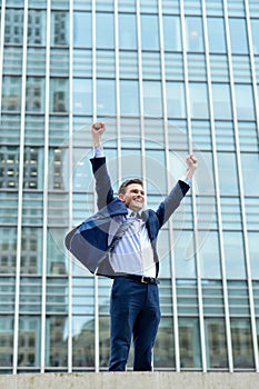 Excited businessman raising his arms