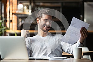 Excited businessman reading postal mail letter overjoyed by great news