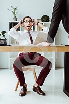 excited businessman talking with boss at workplace