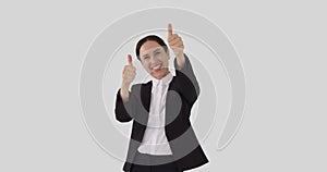 Excited businesswoman giving thumbs up gesture