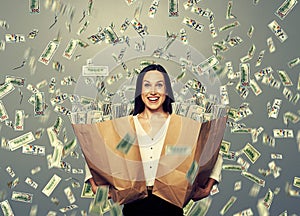 Excited businesswoman with money