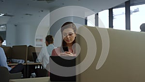 Excited businesswoman reading good news on smartphone screen at workplace