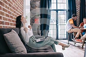 excited businesswoman showing winner gesture while