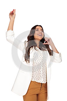 Excited businesswoman speaking on the phone and halding head up