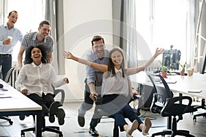 Excited carefree diverse office workers having fun during work b