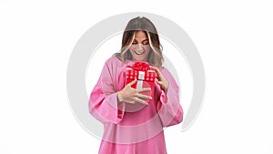 Excited casual woman opening red wrapped gift box rejoicing isolated. 4k Dragon RED camera